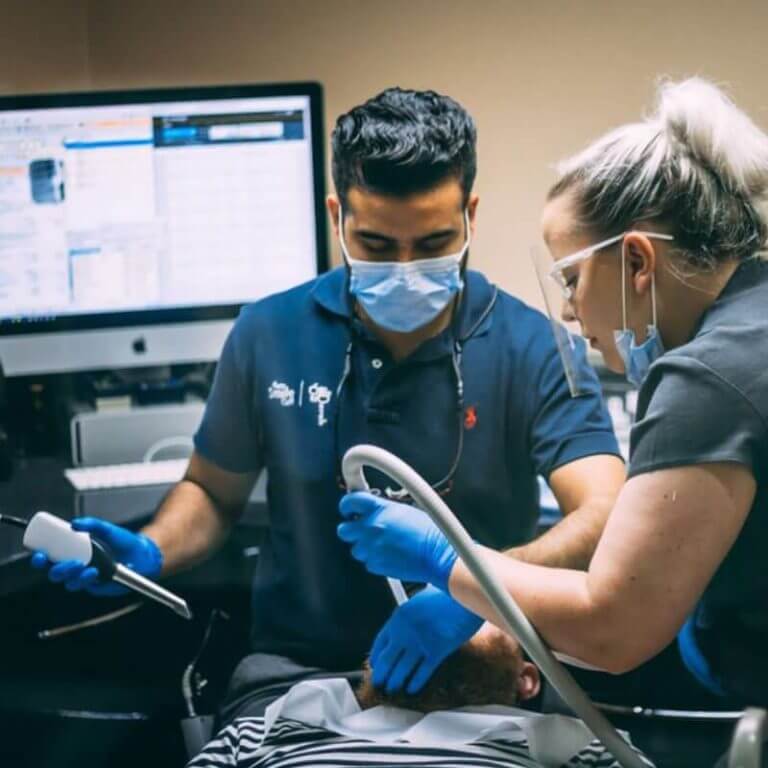 Image of an ollie and darsh cosmetic dentist carrying out invisalign treatment