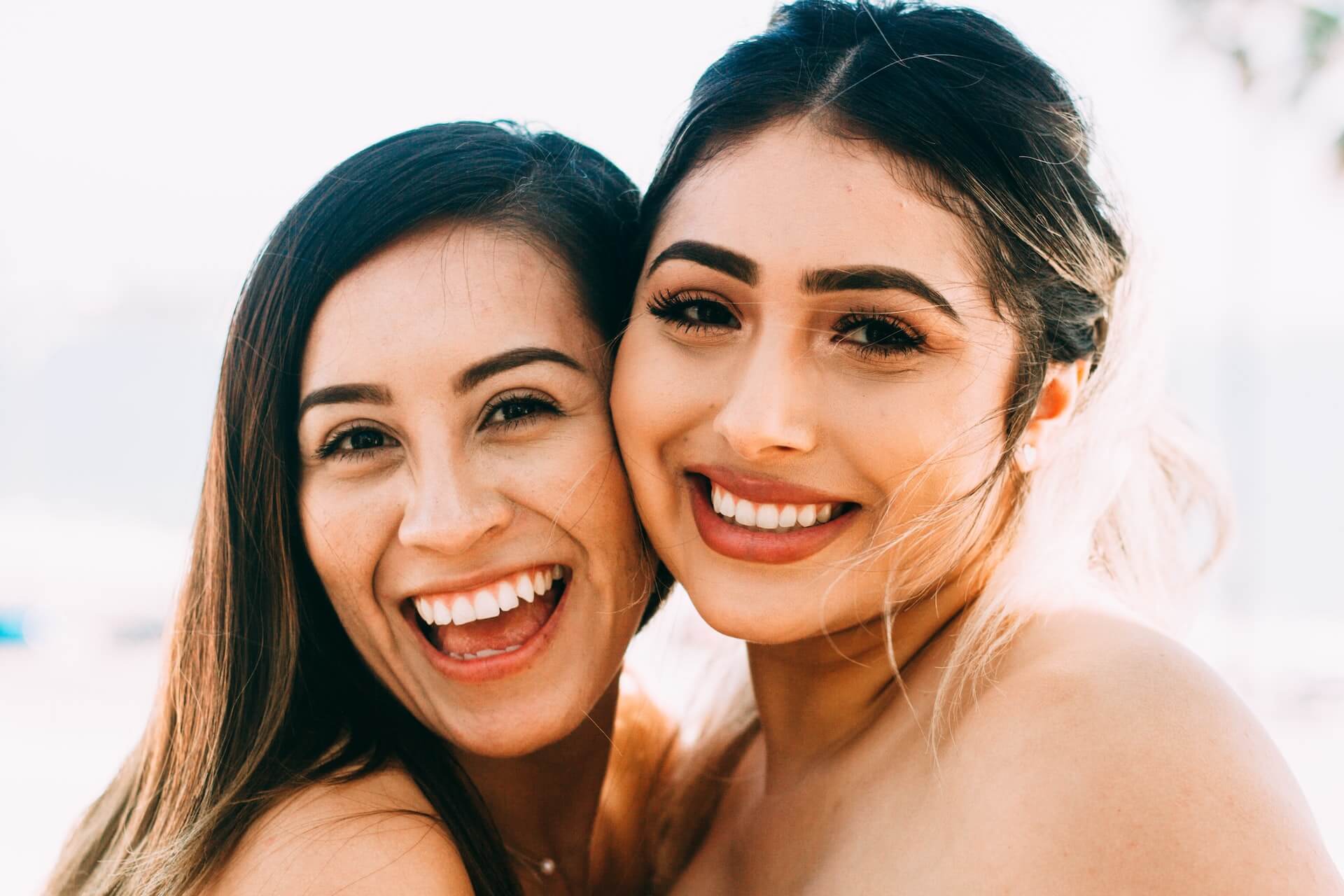 an image of two girls happy with the benefits of composite bonding