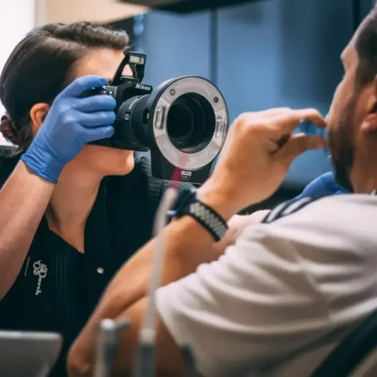 an image of an ollie and darsh dentist taking a before picture of teeth without dental crowns